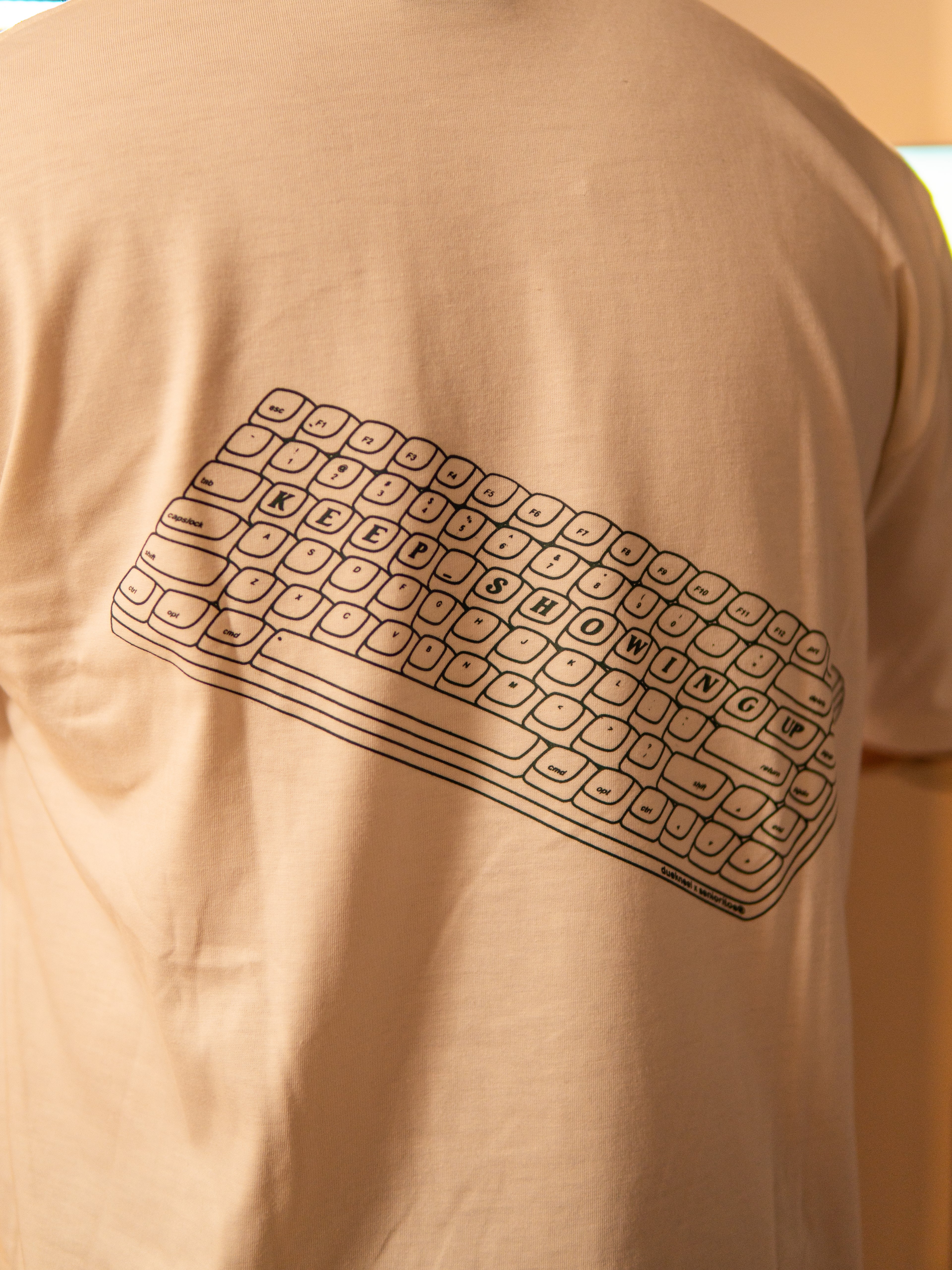 KEEP SHOWING UP REGULAR TEE | CREAM | DUEKNEELxSENIORITOS® COLLABORATION