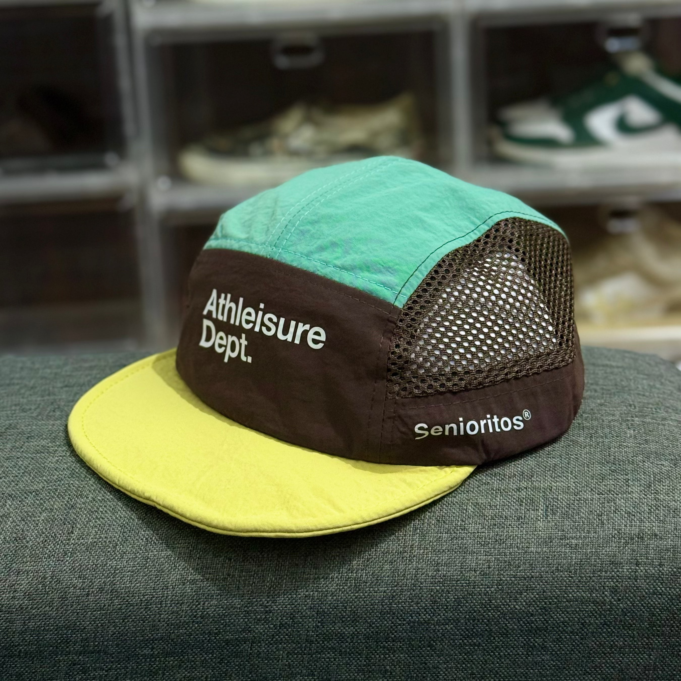 Multicolored cap with text on a surface with shoes in the background